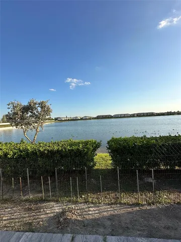a view of a lake with houses in the back
