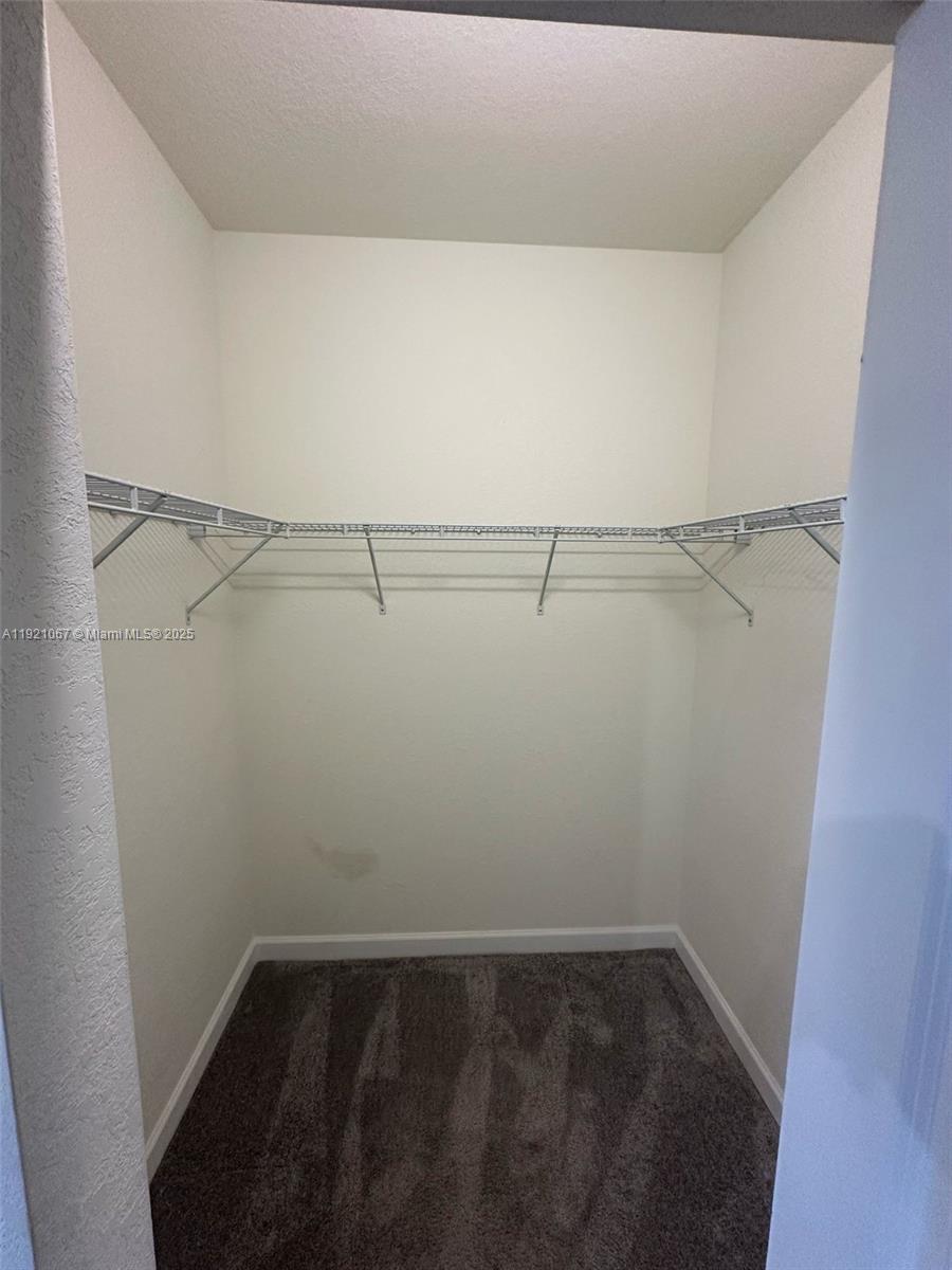 3302 West 114th Terrace Hialeah, FL 33018 - Photo 18 of 30 a view of a room with racks on the wall