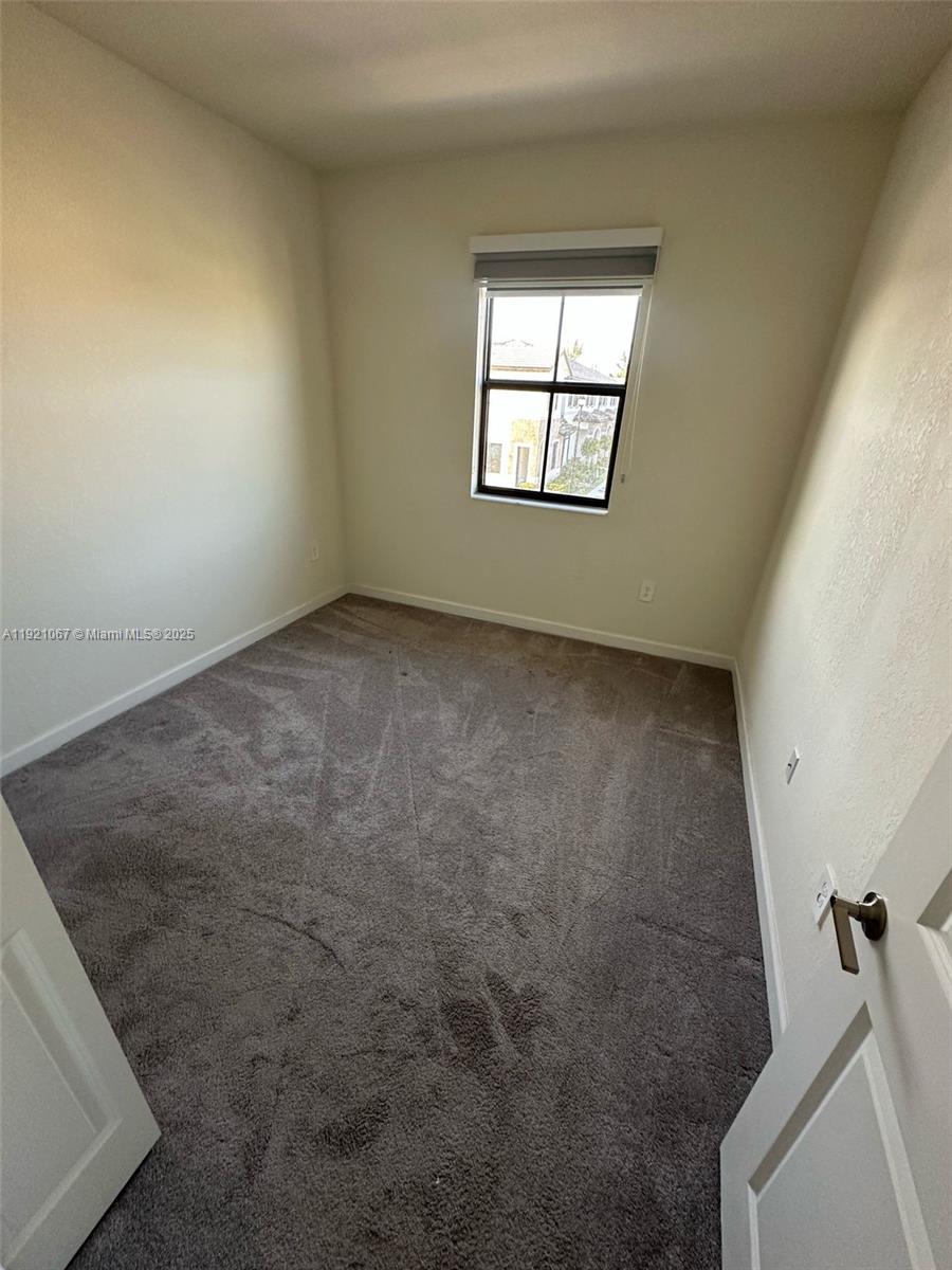 3302 West 114th Terrace Hialeah, FL 33018 - Photo 24 of 30 an empty room with windows