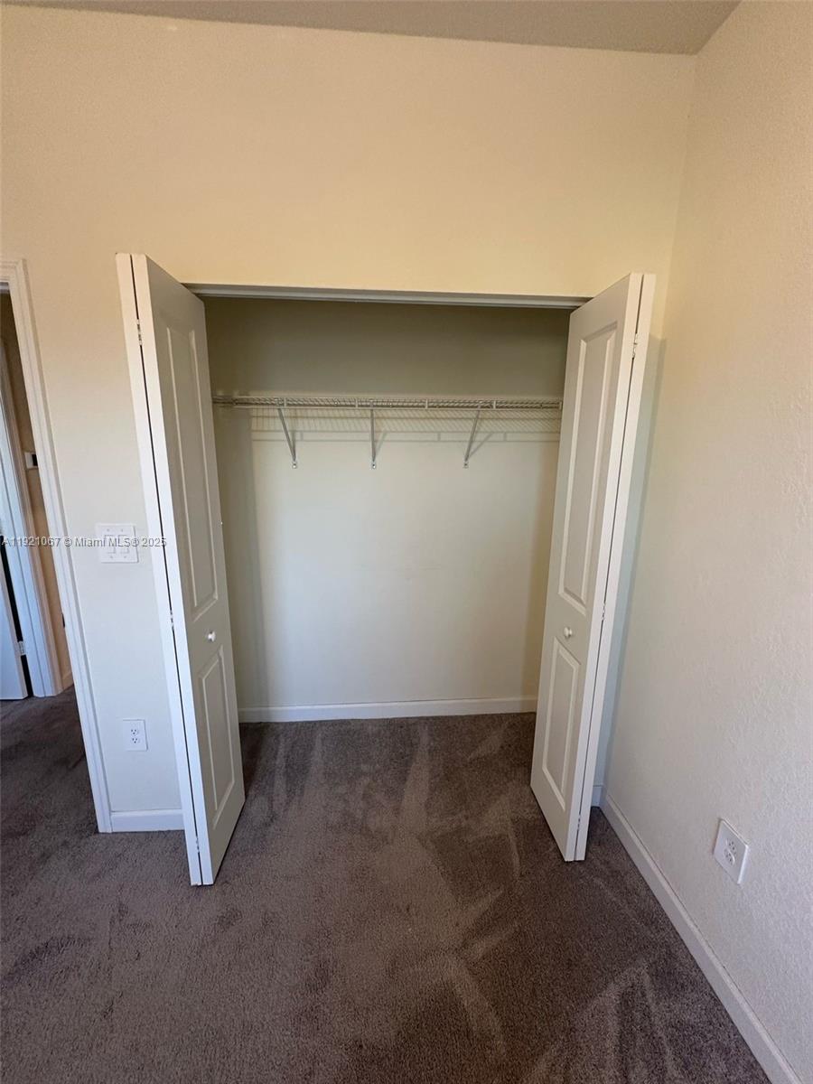 3302 West 114th Terrace Hialeah, FL 33018 - Photo 25 of 30 an empty room with a bench