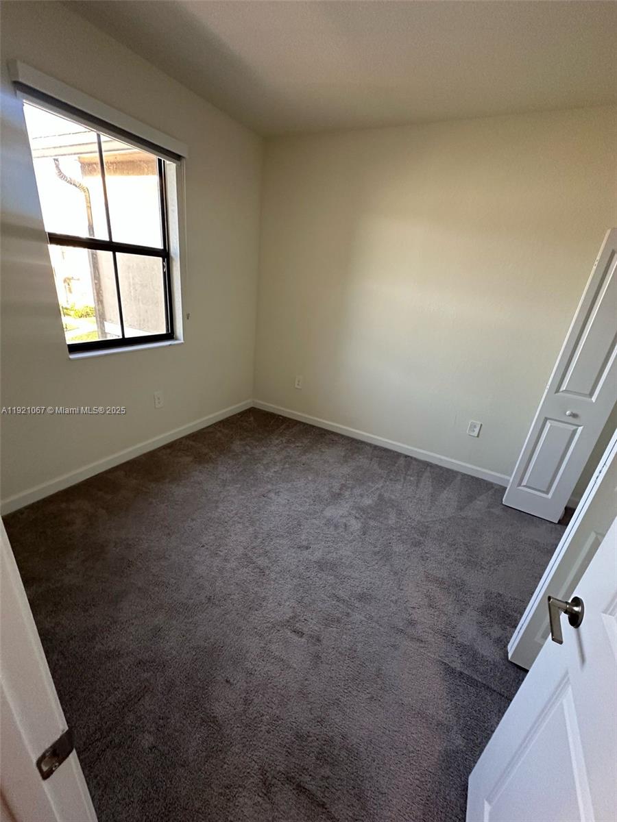 3302 West 114th Terrace Hialeah, FL 33018 - Photo 26 of 30 an empty room with windows