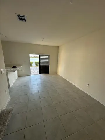 a view of a kitchen with an empty space and a sink