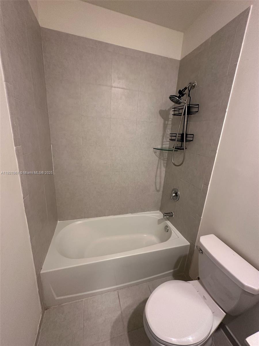 3302 West 114th Terrace Hialeah, FL 33018 - Photo 30 of 30 a white bath tub sitting next to a white toilet
