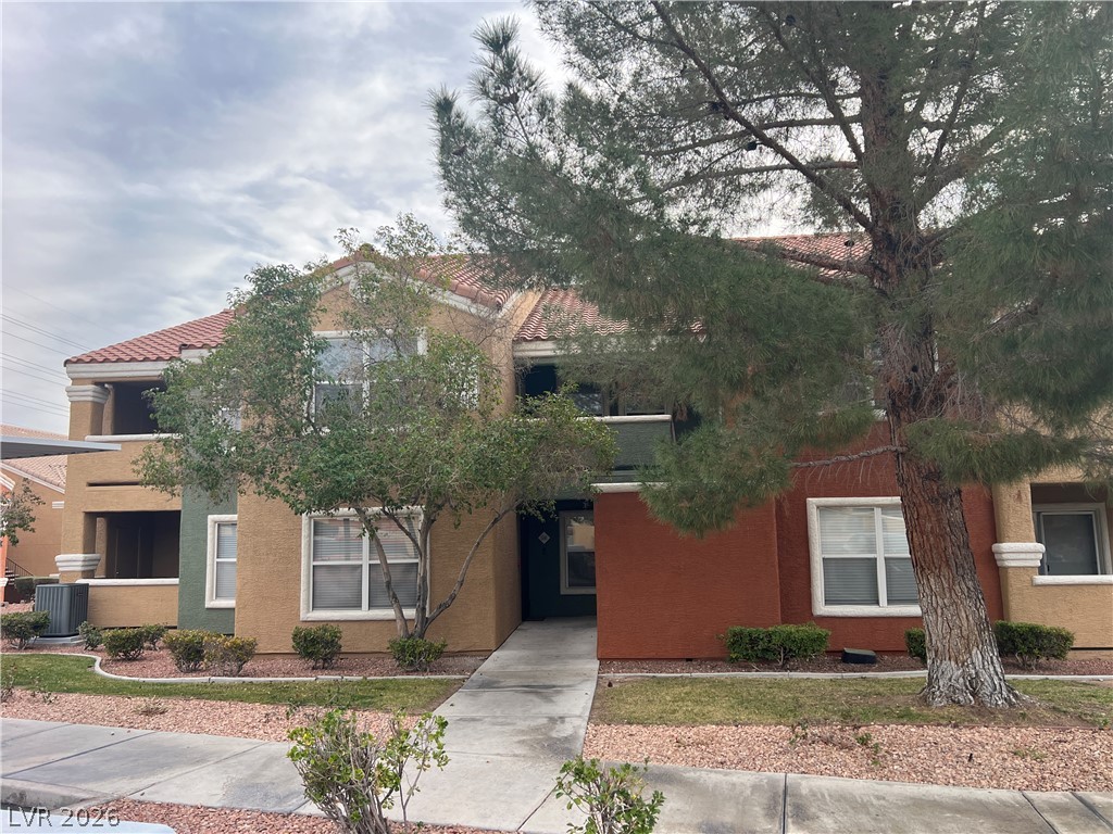 8101 West Flamingo Road, Unit 2161 Las Vegas, NV 89147 - Photo 4 of 15 Multi-level living awaits with a welcoming entrance and vibrant landscaping.
