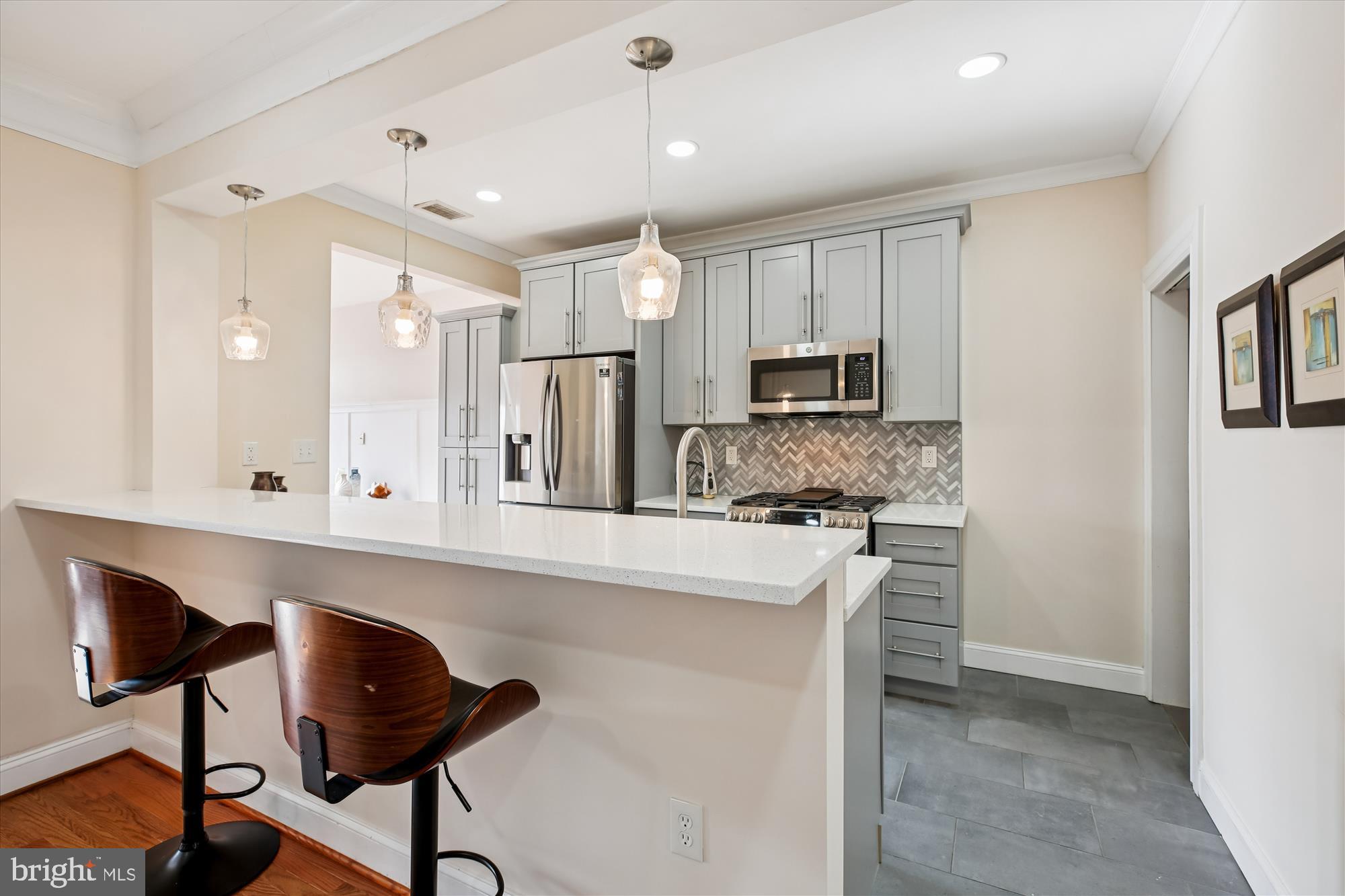 1412 Allison Street Northwest Washington, DC 20011 - Photo 11 of 62 a large kitchen with kitchen island white cabinets and stainless steel appliances