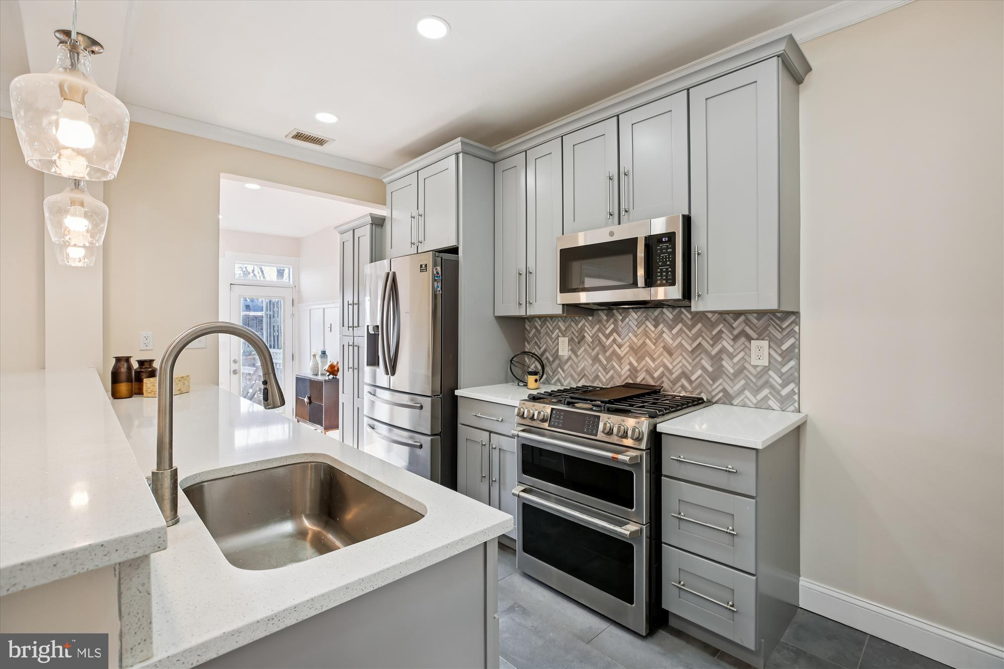 1412 Allison Street Northwest Washington, DC 20011 - Photo 13 of 62 a kitchen with a stove a sink and a microwave