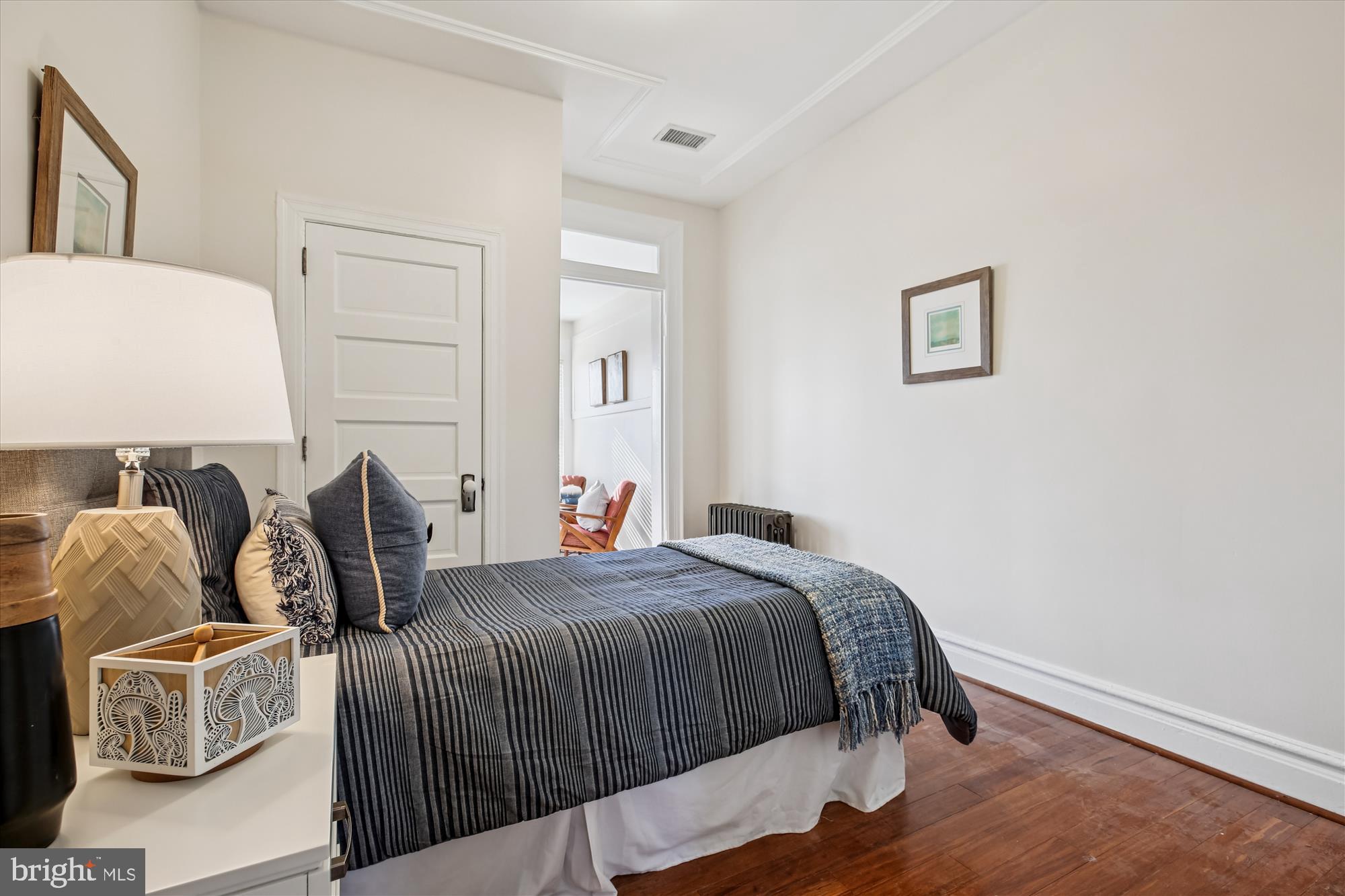 1412 Allison Street Northwest Washington, DC 20011 - Photo 36 of 62 a bedroom with a bed and wooden floor