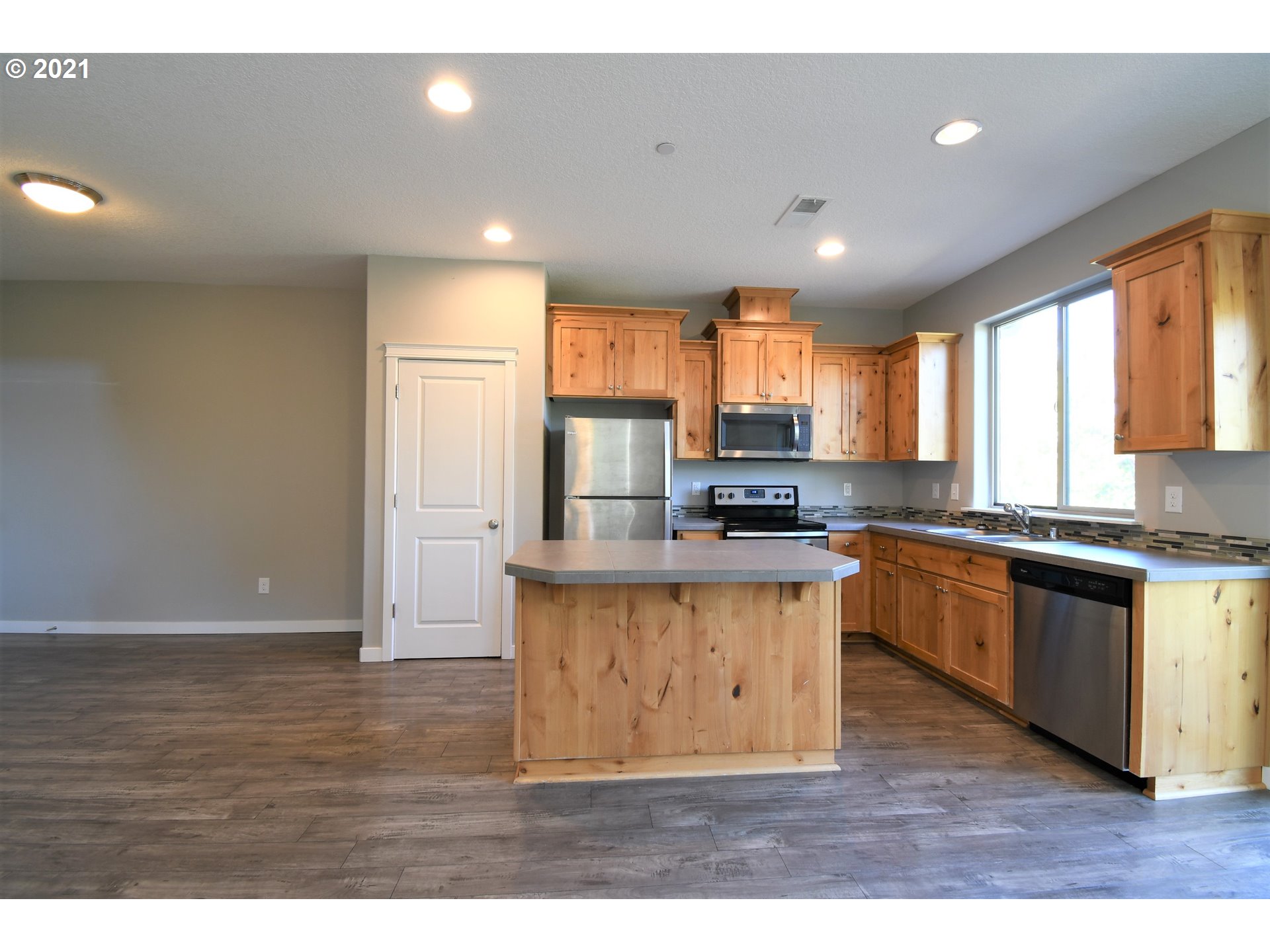 4361 North 2nd Way Ridgefield, WA 98642 - Photo 3 of 19 a kitchen with stainless steel appliances granite countertop a sink a stove a refrigerator cabinets and a large window