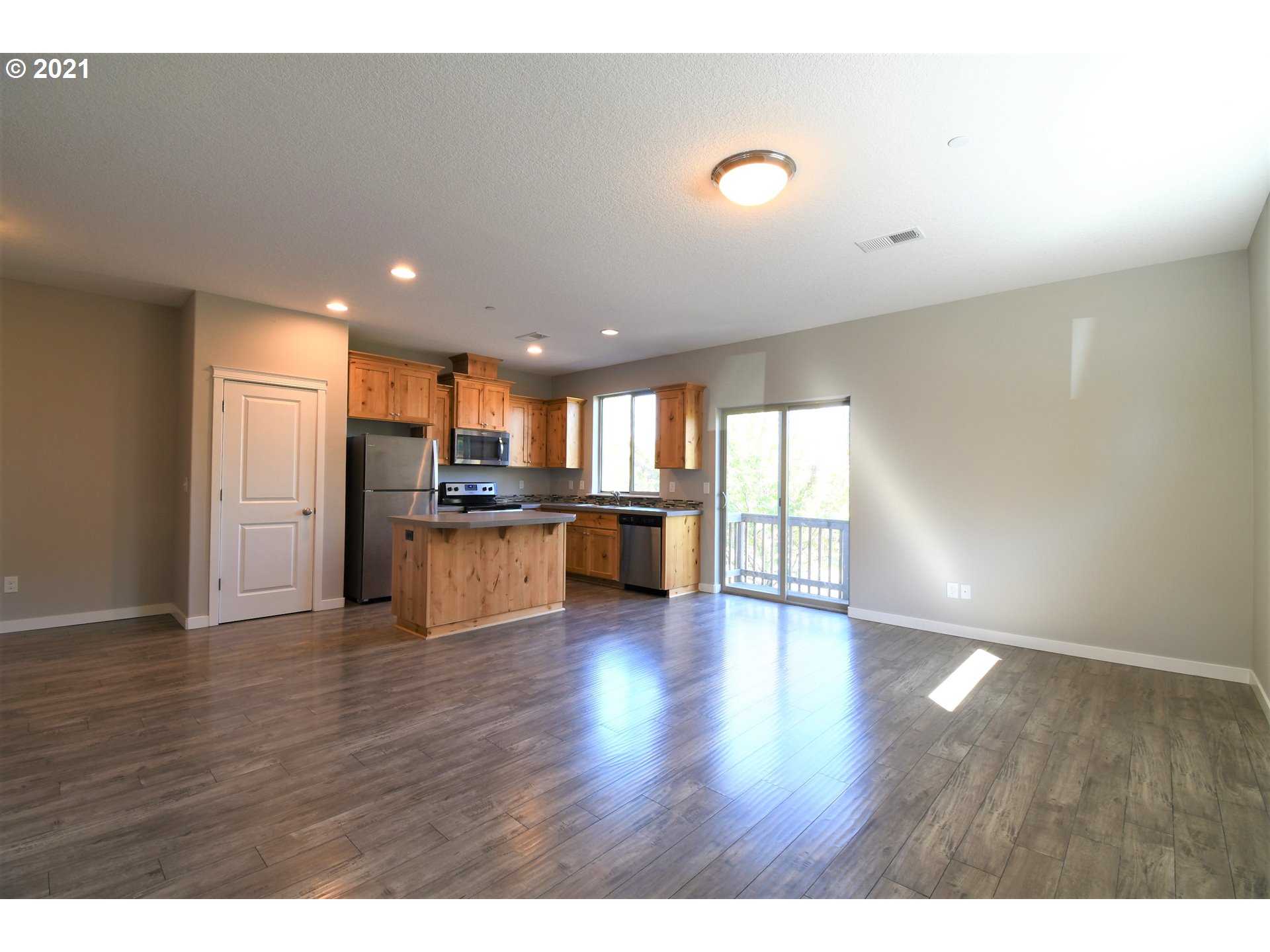 4361 North 2nd Way Ridgefield, WA 98642 - Photo 5 of 19 a view of kitchen with refrigerator and wooden floor