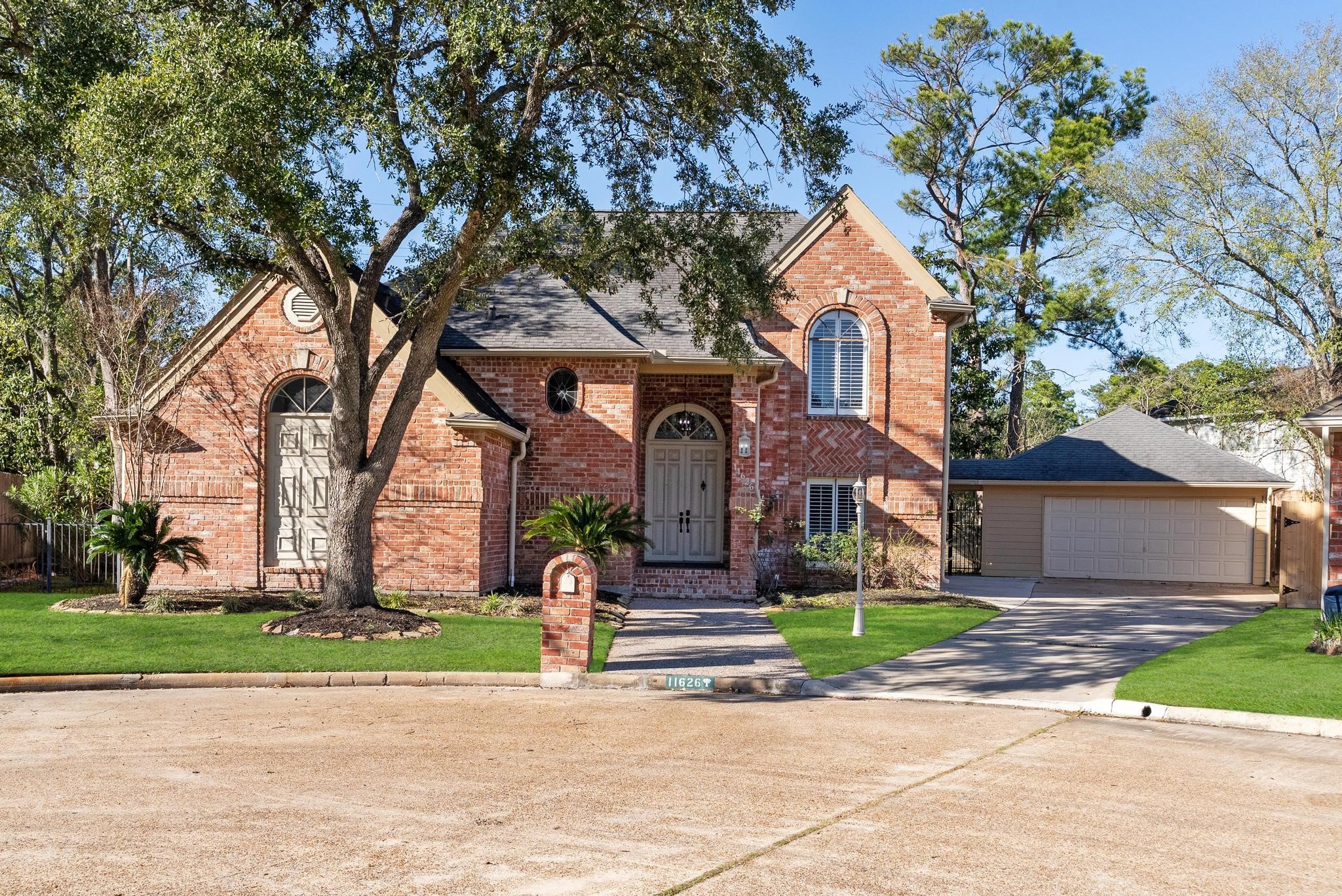 a front view of house with yard and green space