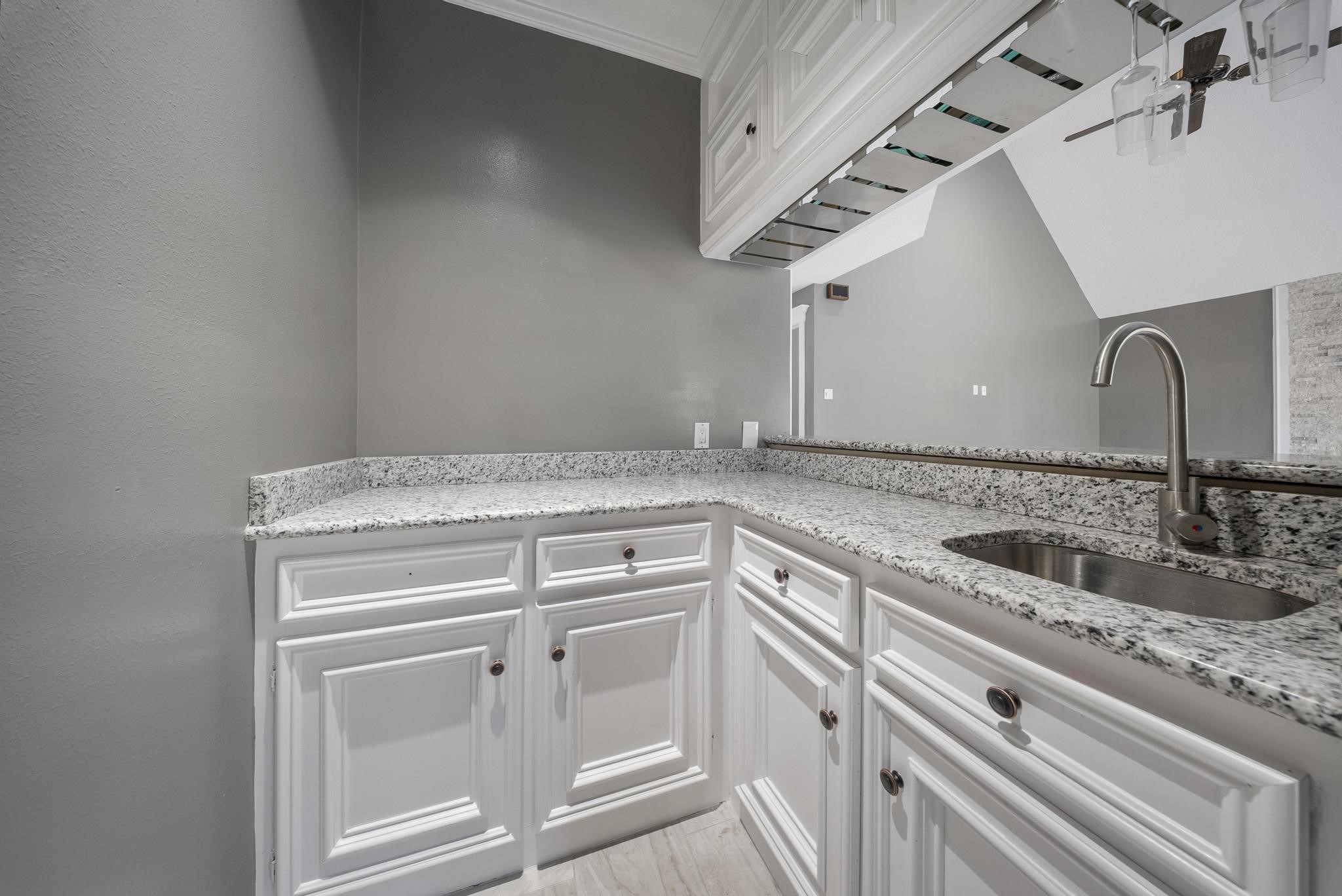 11626 Taos Lane Houston, TX 77070 - Photo 11 of 32 a view with granite countertop a sink and cabinets