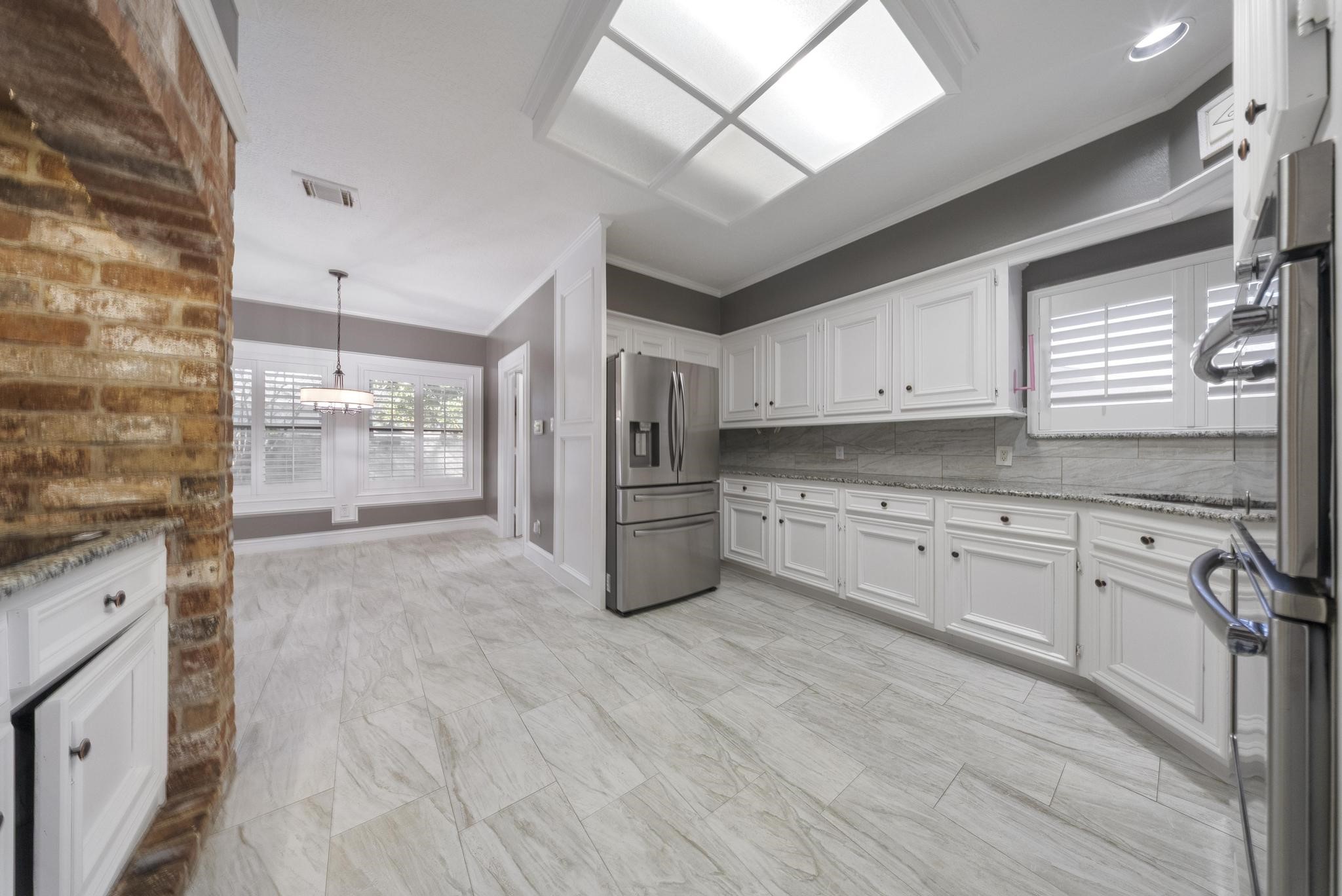 11626 Taos Lane Houston, TX 77070 - Photo 17 of 32 a kitchen with stainless steel appliances a refrigerator sink and cabinets