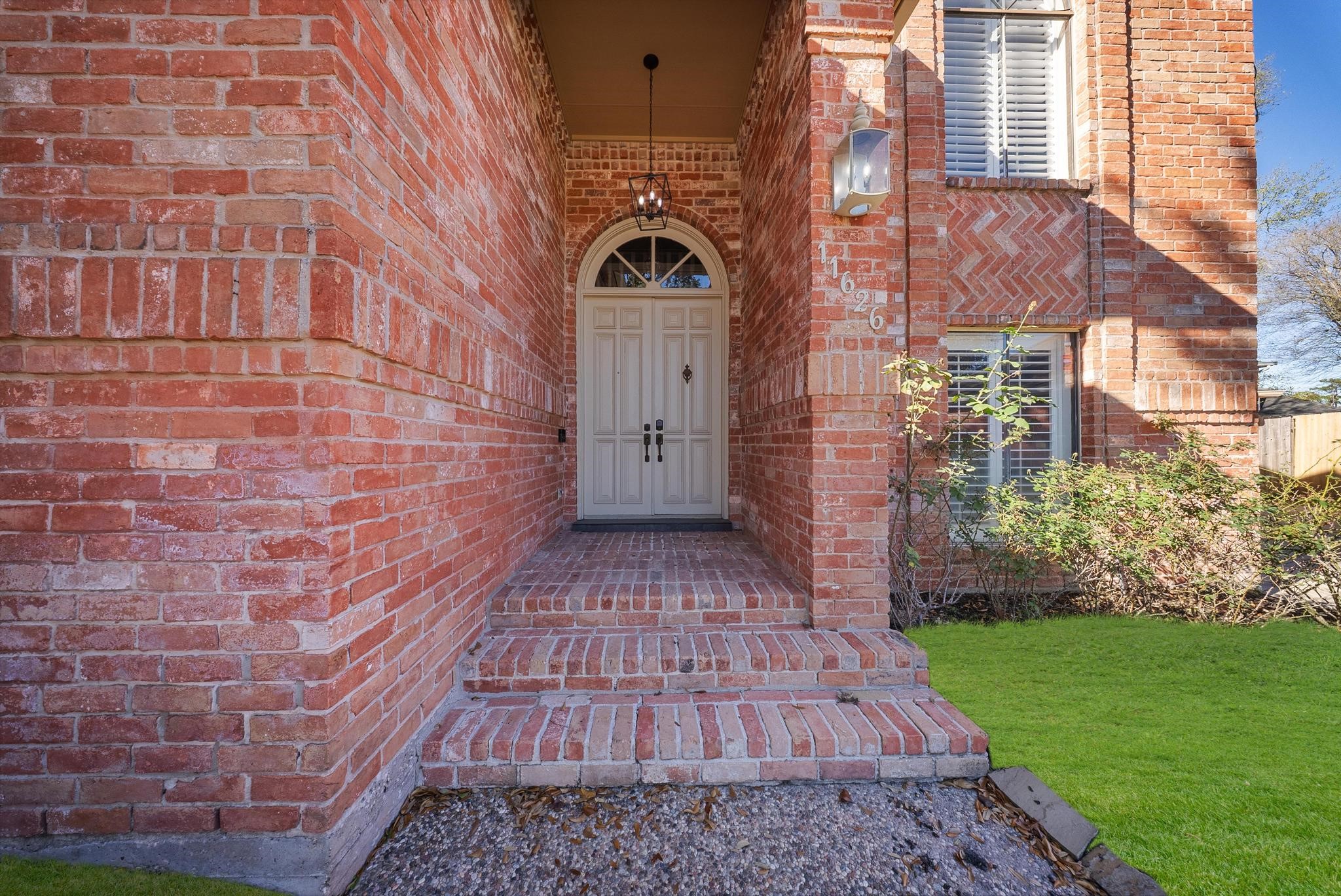 11626 Taos Lane Houston, TX 77070 - Photo 4 of 32 a view of a brick house with a big yard