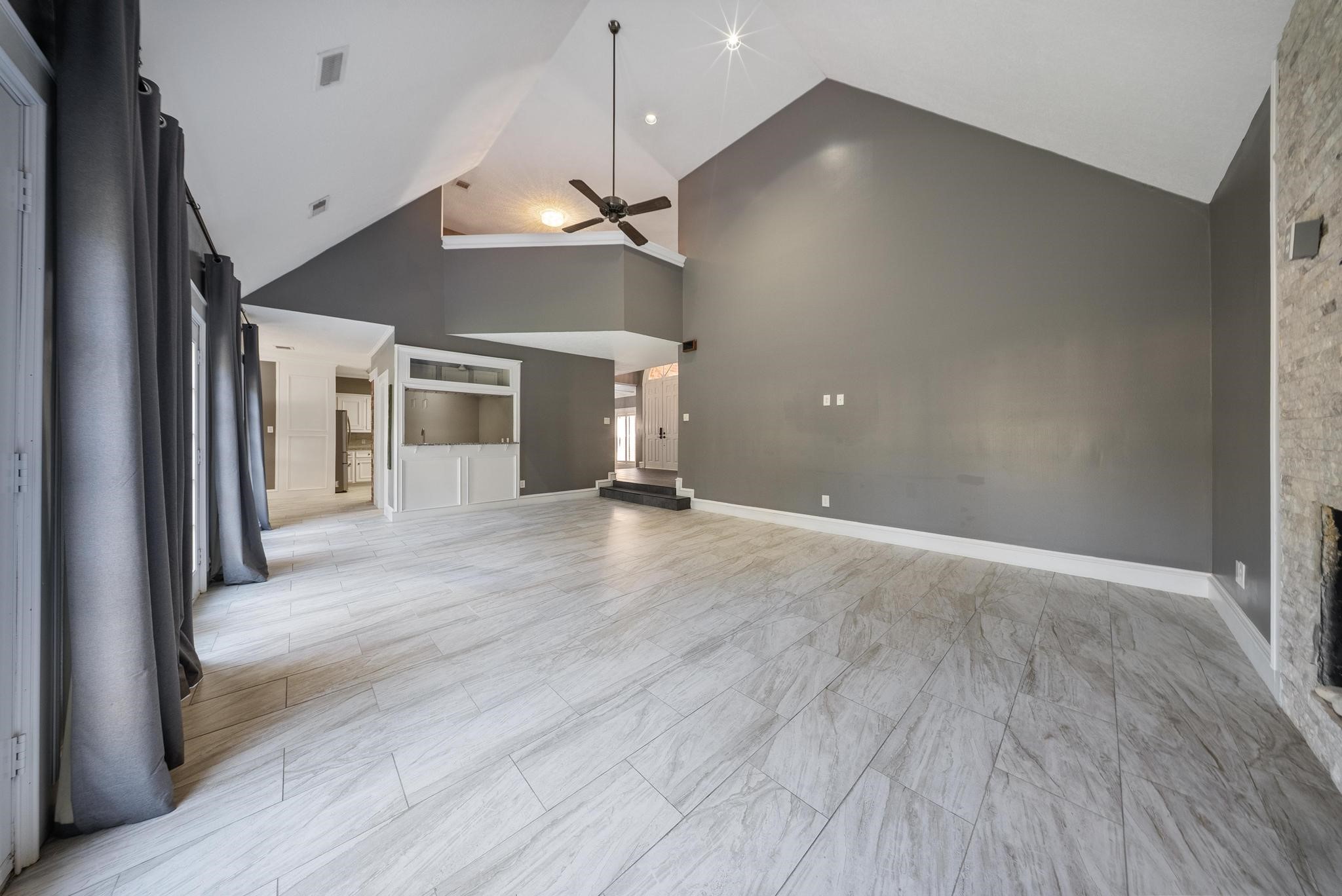 11626 Taos Lane Houston, TX 77070 - Photo 7 of 32 an empty room with wooden floor and a ceiling fan