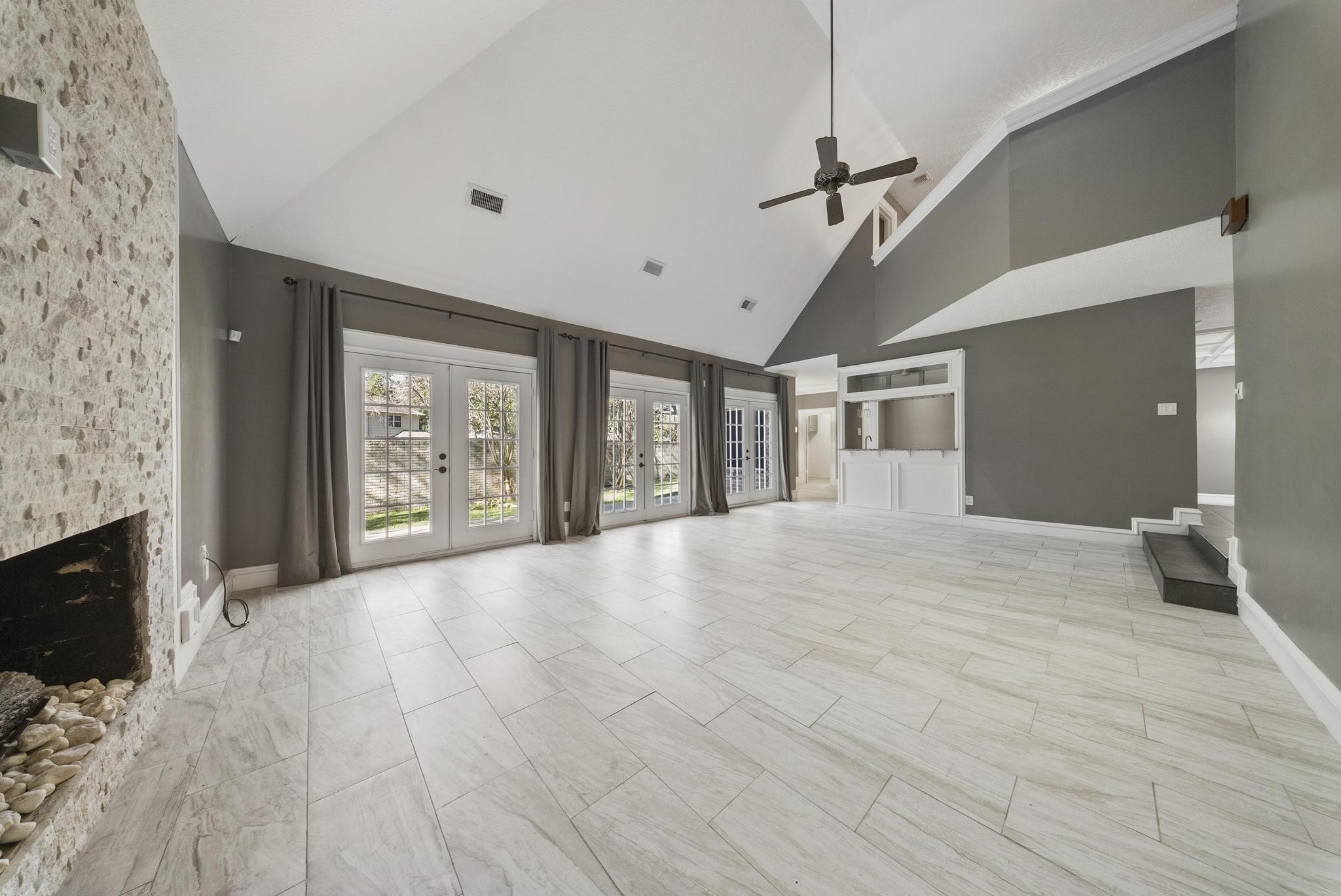 11626 Taos Lane Houston, TX 77070 - Photo 8 of 32 a view of an empty room with a fireplace and windows
