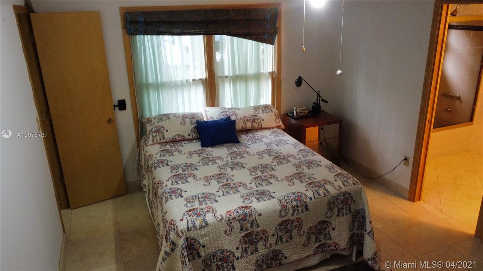 Key Biscayne Key Biscayne, FL 33149 - Photo 14 of 20 a bed sitting in a bedroom next to a window