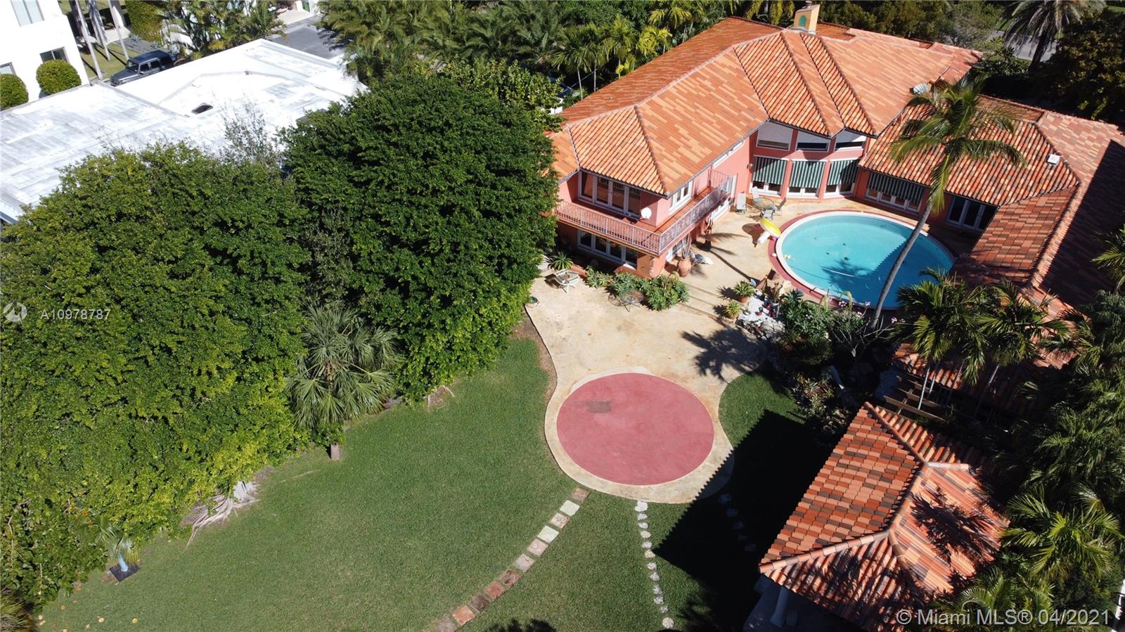 Key Biscayne Key Biscayne, FL 33149 - Photo 17 of 20 a aerial view of a house with a swimming pool and red umbrella