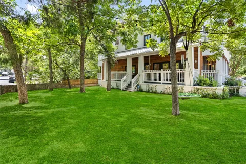 a view of house with a yard