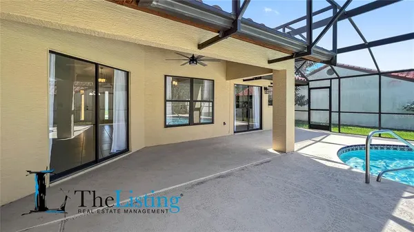 a backyard of a house with table and chairs