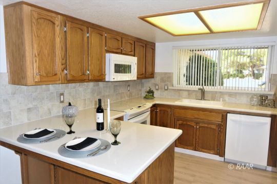 1122 North Inyo Street Ridgecrest, CA 93555 - Photo 12 of 34 a kitchen with kitchen island granite countertop counter space a sink and a window