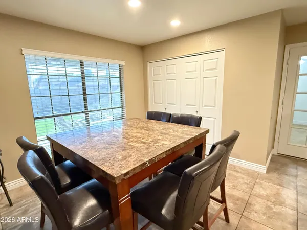 a dining room with furniture and window