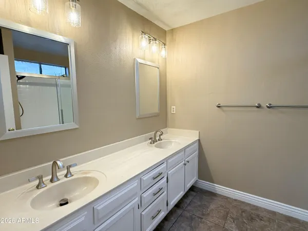 a bathroom with a double vanity sink and a mirror