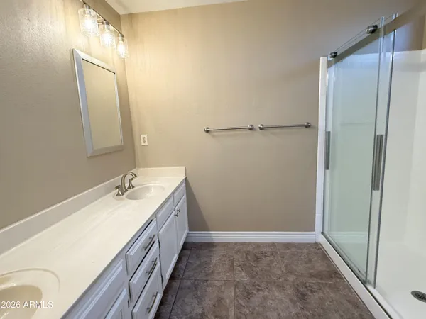 a bathroom with a double vanity sink and mirror