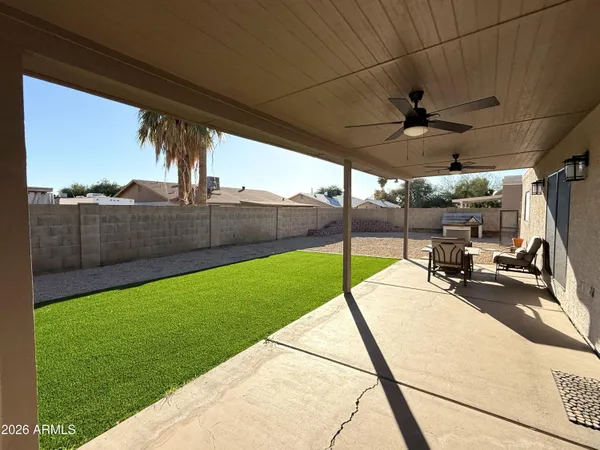 a view of a swimming pool with a lawn chairs under an umbrella