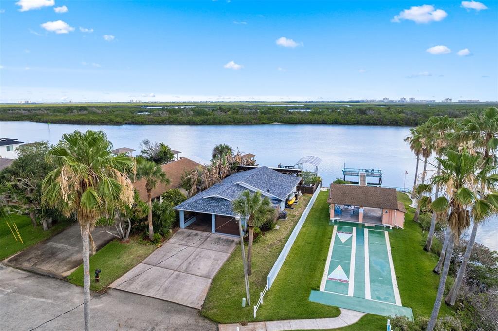29 Pelican Lane Edgewater, FL 32141 - Photo 33 of 39 a view of a lake with couches and city view