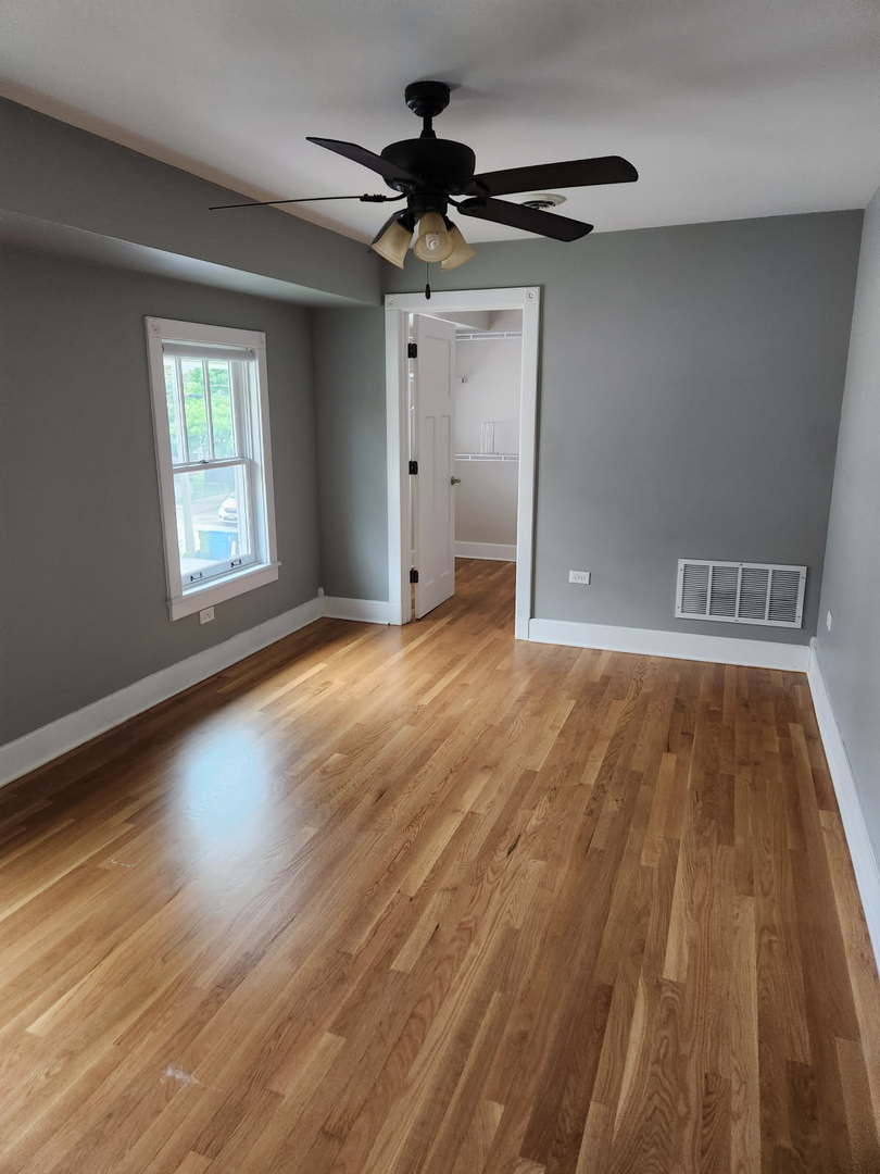 532 Beloit Avenue, Unit 2 Forest Park, IL 60130 - Photo 6 of 12 a view of an empty room with wooden floor and a window