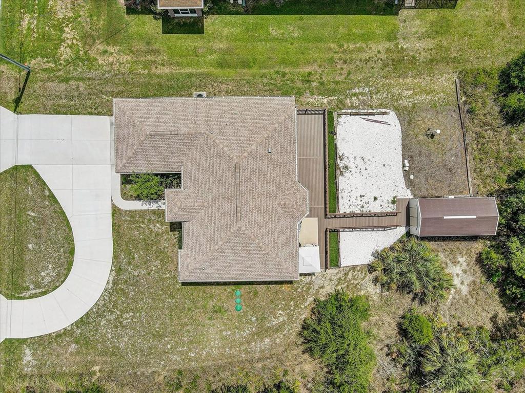 7314 Madrid Road Weeki Wachee, FL 34613 - Photo 34 of 54 an aerial view of a house with swimming pool and large trees