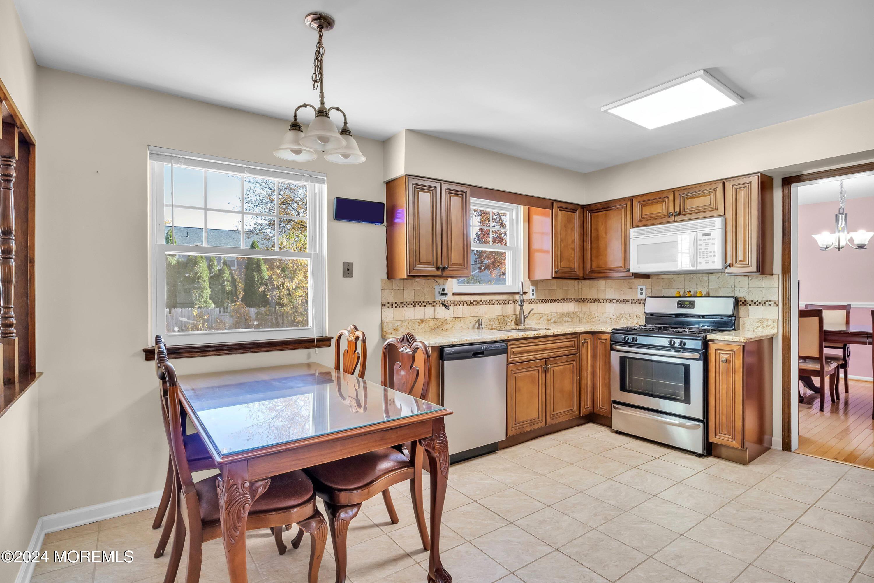 17 Willow Ridge Road Marlton, NJ 08053 - Photo 8 of 36 a kitchen with stainless steel appliances granite countertop a stove top oven a sink dishwasher a dining table and chairs
