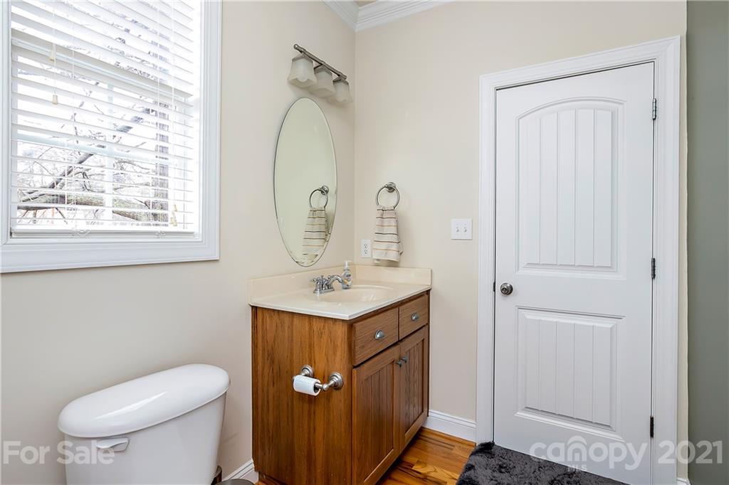 21036 Rio Oro Drive Cornelius, NC 28031 - Photo 20 of 29 a bathroom with a toilet a sink and mirror