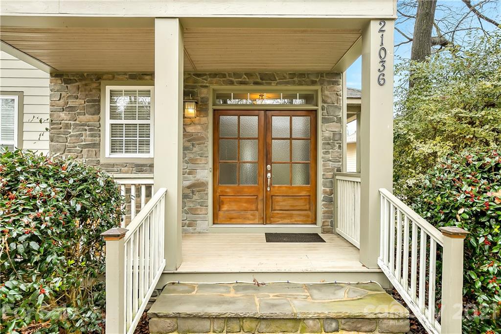 21036 Rio Oro Drive Cornelius, NC 28031 - Photo 3 of 29 a view of entrance gate of a house with large windows