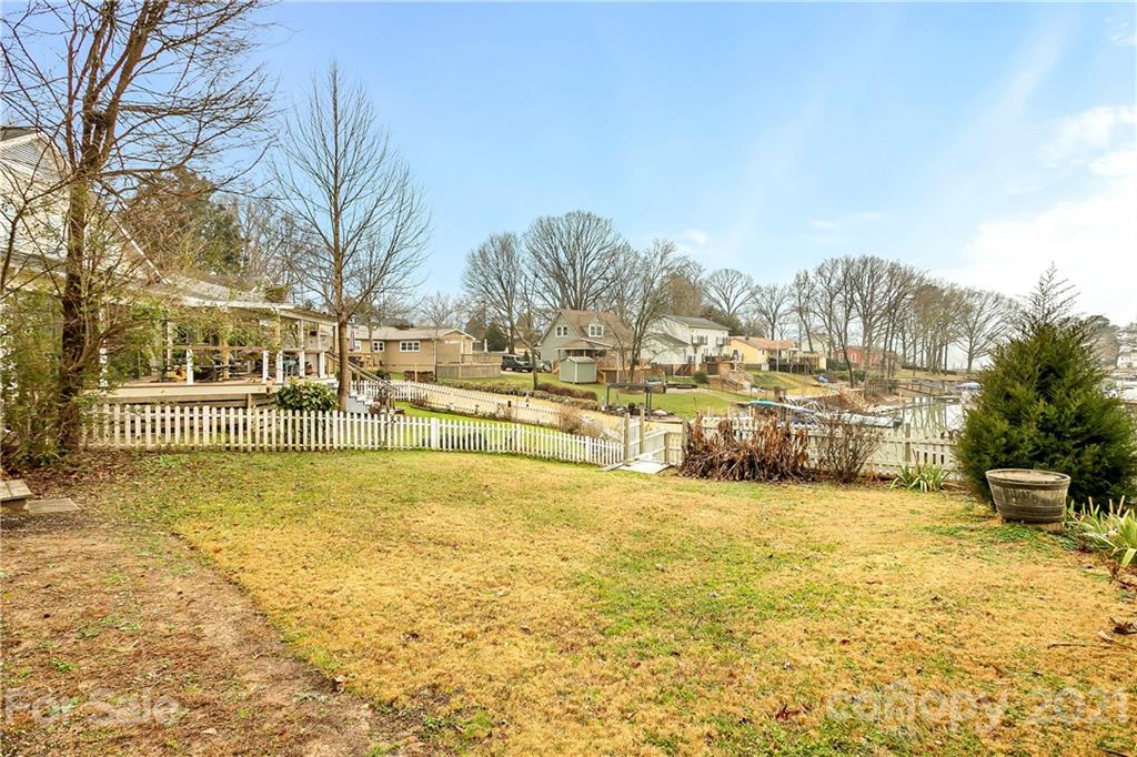 21036 Rio Oro Drive Cornelius, NC 28031 - Photo 26 of 29 a view of a swimming pool with trees and buildings in the background
