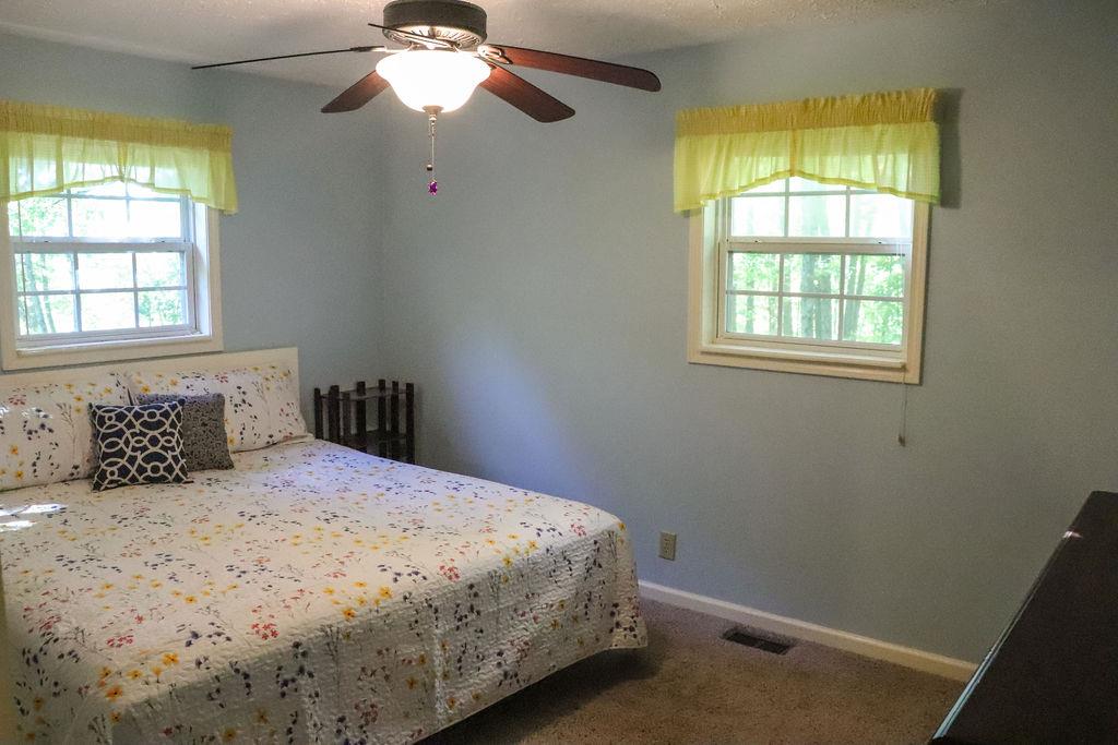 3166 Mt Union Road Byrdstown, TN 38549 - Photo 18 of 29 a bedroom with a bed and a chandelier