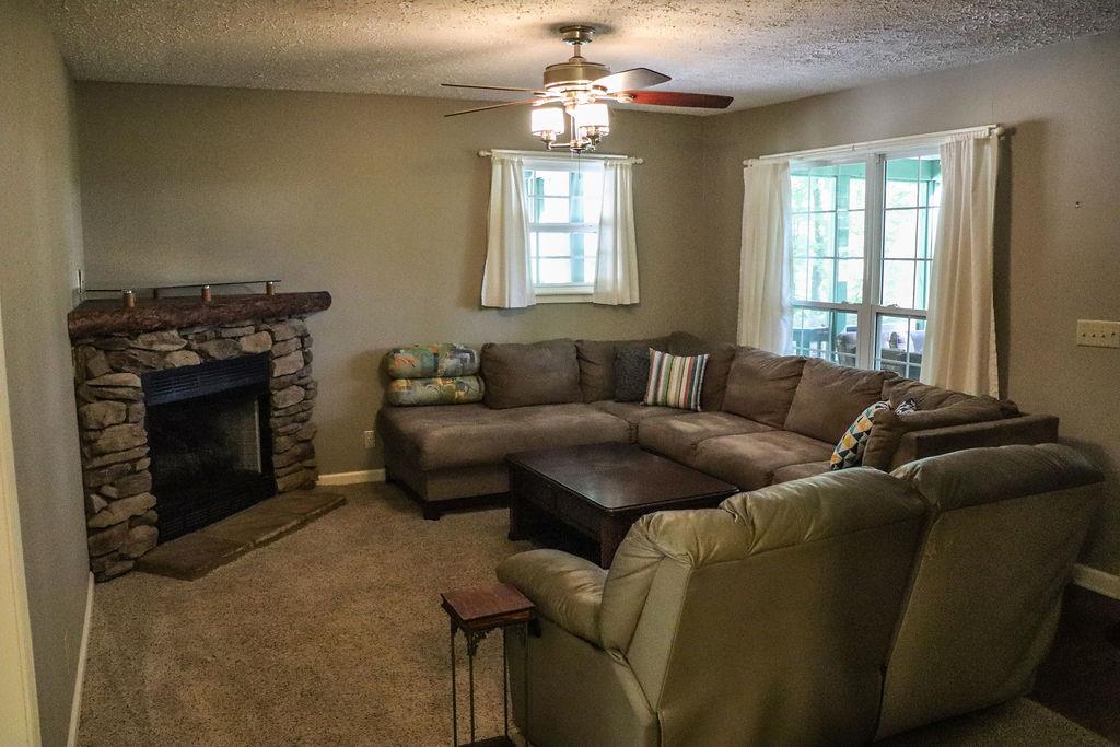 3166 Mt Union Road Byrdstown, TN 38549 - Photo 8 of 29 a living room with furniture a fireplace and a window