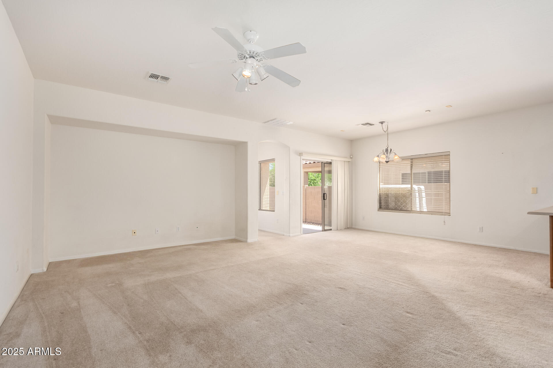 44922 Alamendras Street Maricopa, AZ 85139 - Photo 2 of 26 an empty room with a empty space and windows