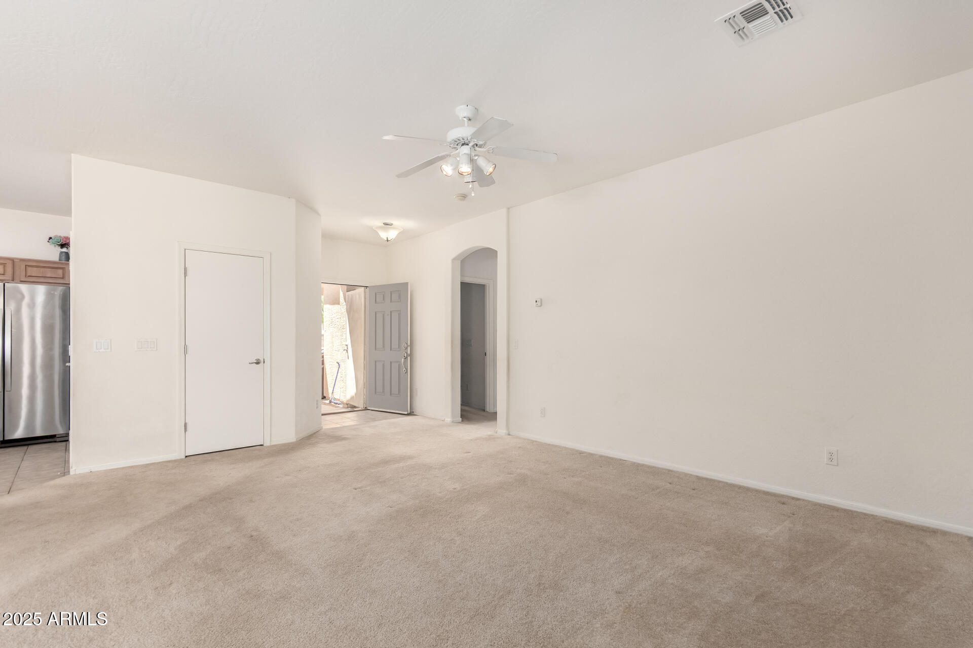 44922 Alamendras Street Maricopa, AZ 85139 - Photo 4 of 26 a view of an empty room with a ceiling fan