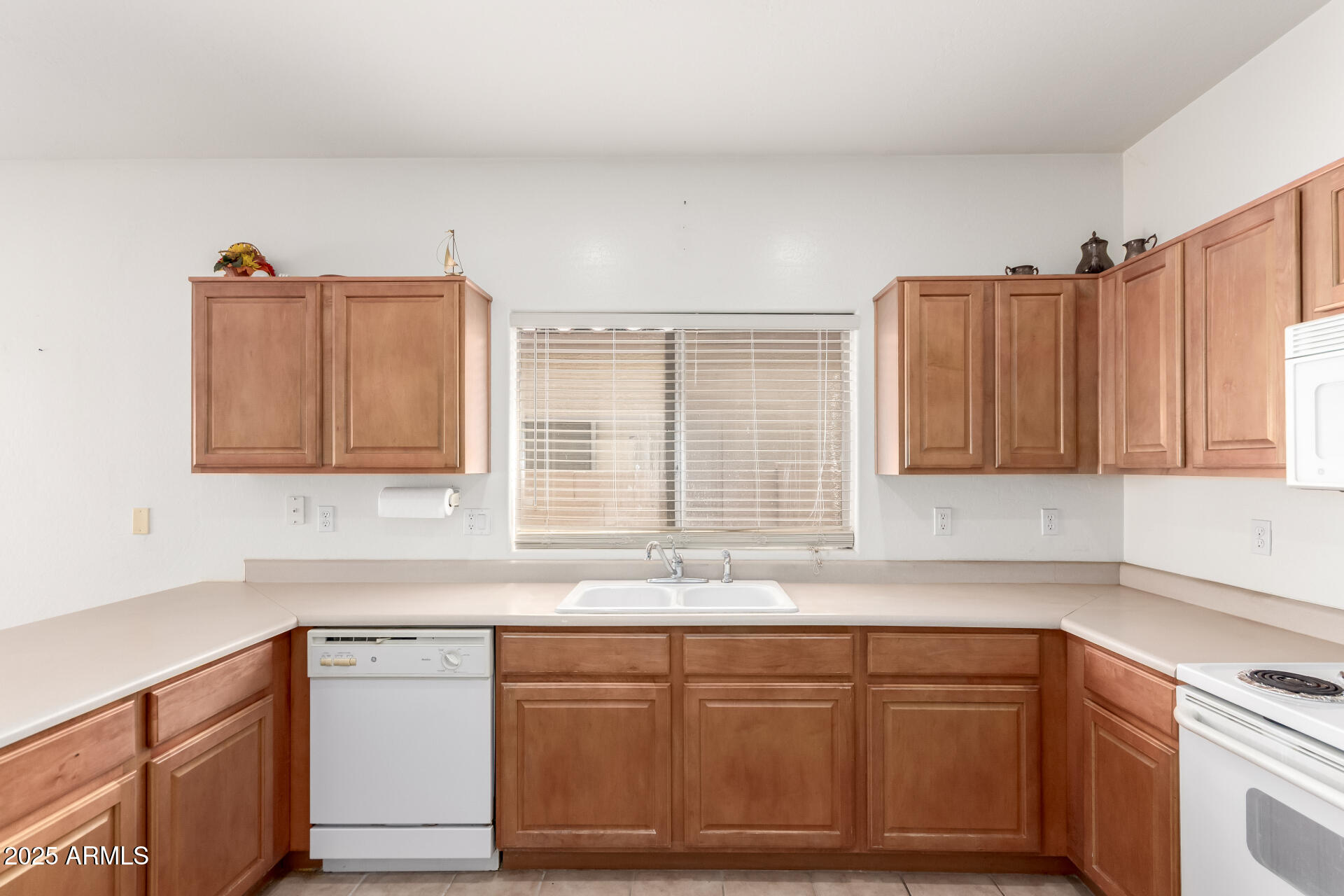 44922 Alamendras Street Maricopa, AZ 85139 - Photo 7 of 26 a kitchen with granite countertop a sink and a white cabinets