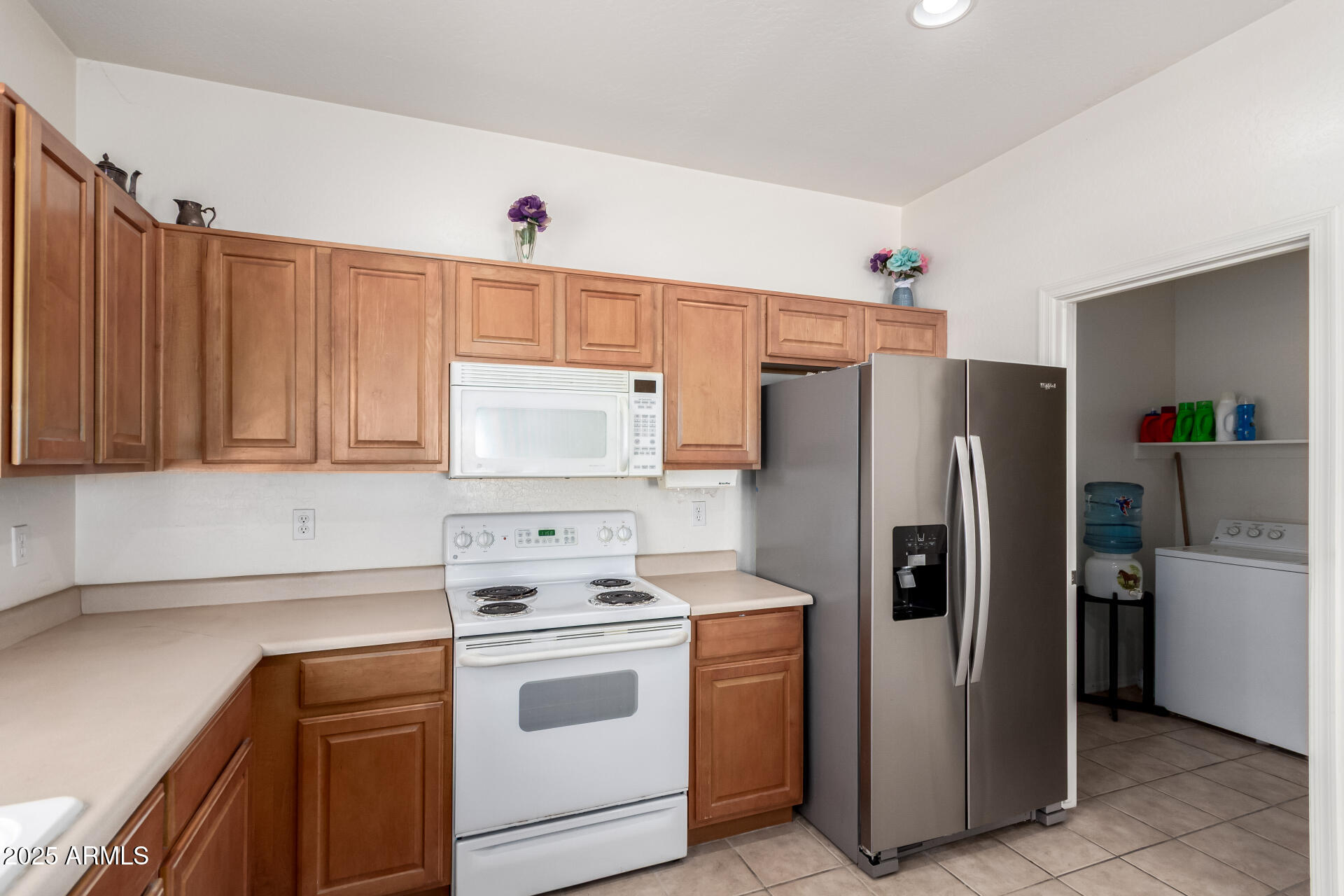 44922 Alamendras Street Maricopa, AZ 85139 - Photo 9 of 26 a kitchen with a refrigerator sink stove and cabinets