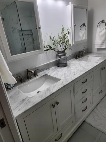 a bathroom with a granite countertop sink a toilet and shower curtain