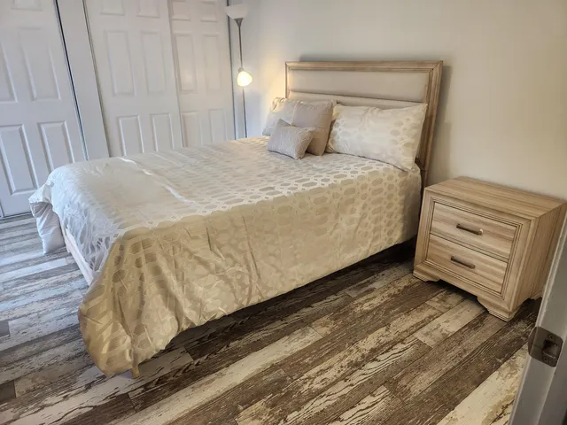a bedroom with a bed and dresser