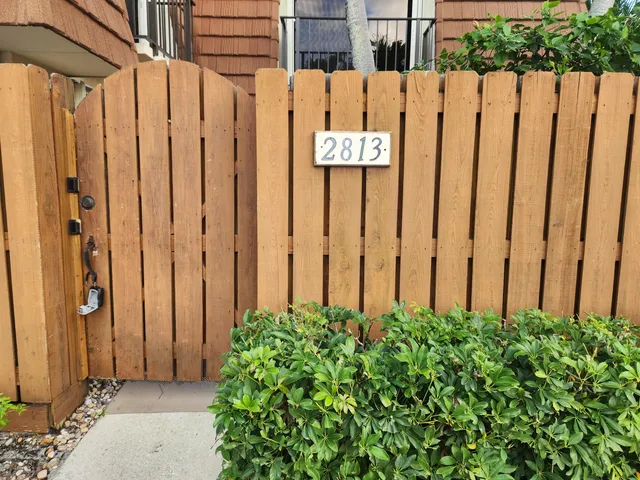 a view of a sign on the wooden fence