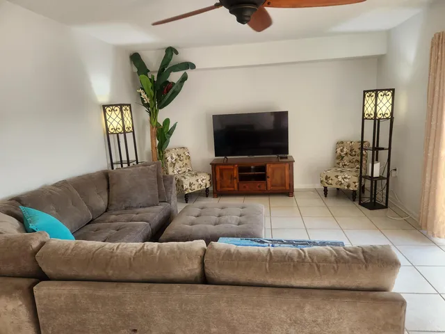 a living room with furniture and a flat screen tv