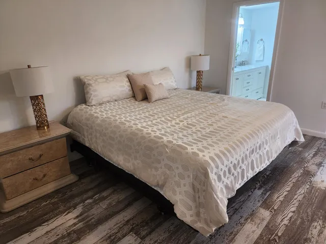 a bedroom with a bed and night stand