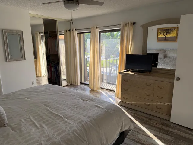 a bedroom with a bed and a mirror