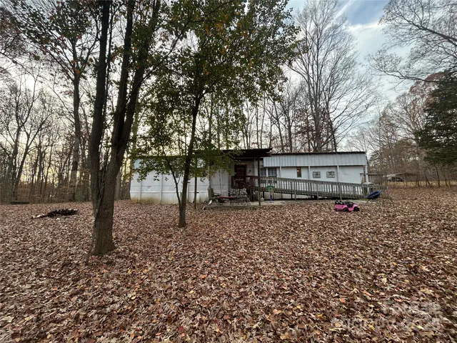 a view of a house with a tree in the yard