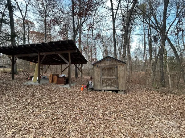 a view of a backyard with a table and chairs under an umbrella