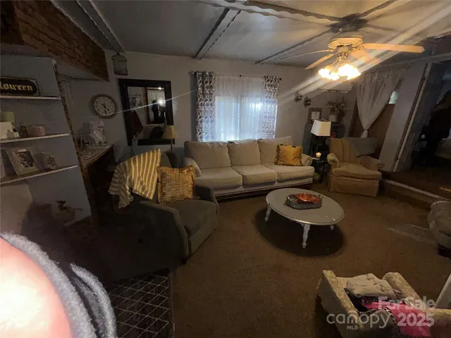 a living room with furniture and a mirror